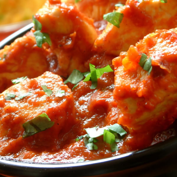 Close-up of paneer tikka masala, garnished with fresh cilantro, from Taste of Punjab.